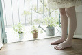 窓辺に立つ女性の足