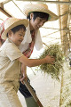 干し草を持つ男の子と父親