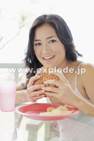 ハンバーガーを食べる日本人女性