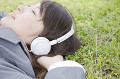 音楽を聴きながら寝そべる女子高生
