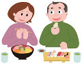 寿司を食べる中高年夫婦