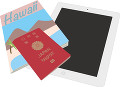 パスポートとタブレットとガイドブック