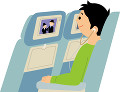 飛行機の機内で映画を観る若い男性