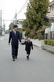 030：手をつないで歩く父と息子