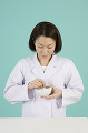 乳鉢と乳棒で薬を調剤する女性薬剤師